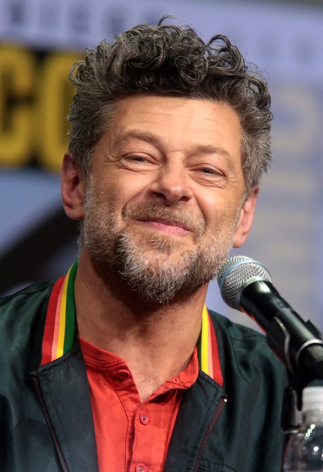 Andy Serkis smiling at a microphone at San Diego Comic-Con in 2017