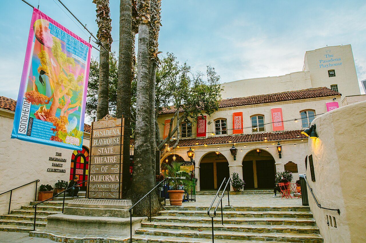 The Spanish-style courtyard and entrance of the Pasadena Playhouse under palm trees