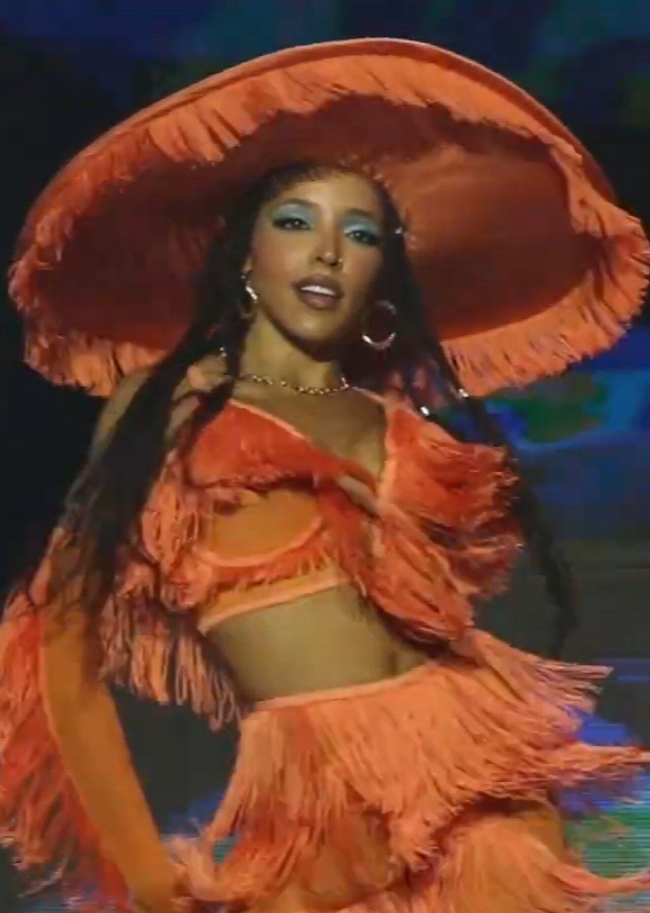 Tinashe performing in an orange fringed hat at Festival Grls in 2023