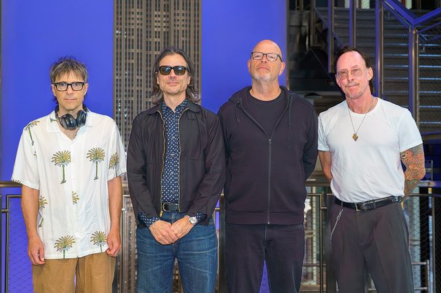 The four members of Weezer at the Empire State Building in 2026